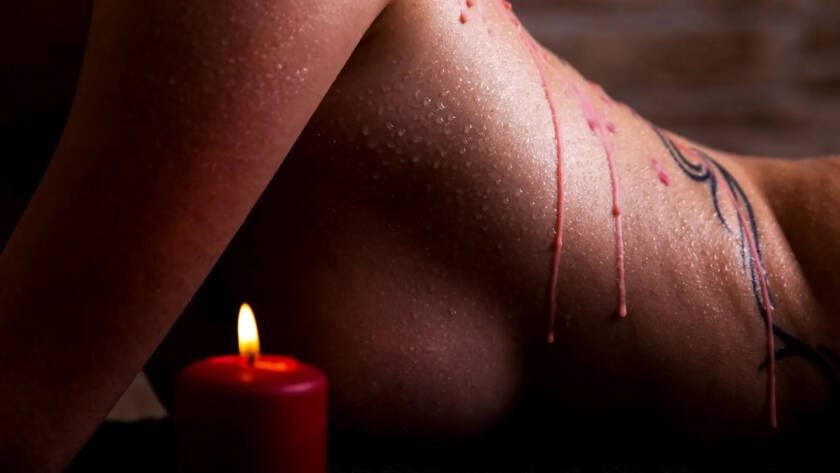 womans back with dripped wax from wax play
